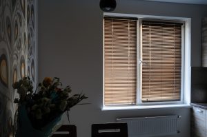 Inside a room with wooden blinds on the window